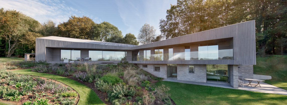 Contemporary house with large glass facade and floor-to-ceiling architectural glazing